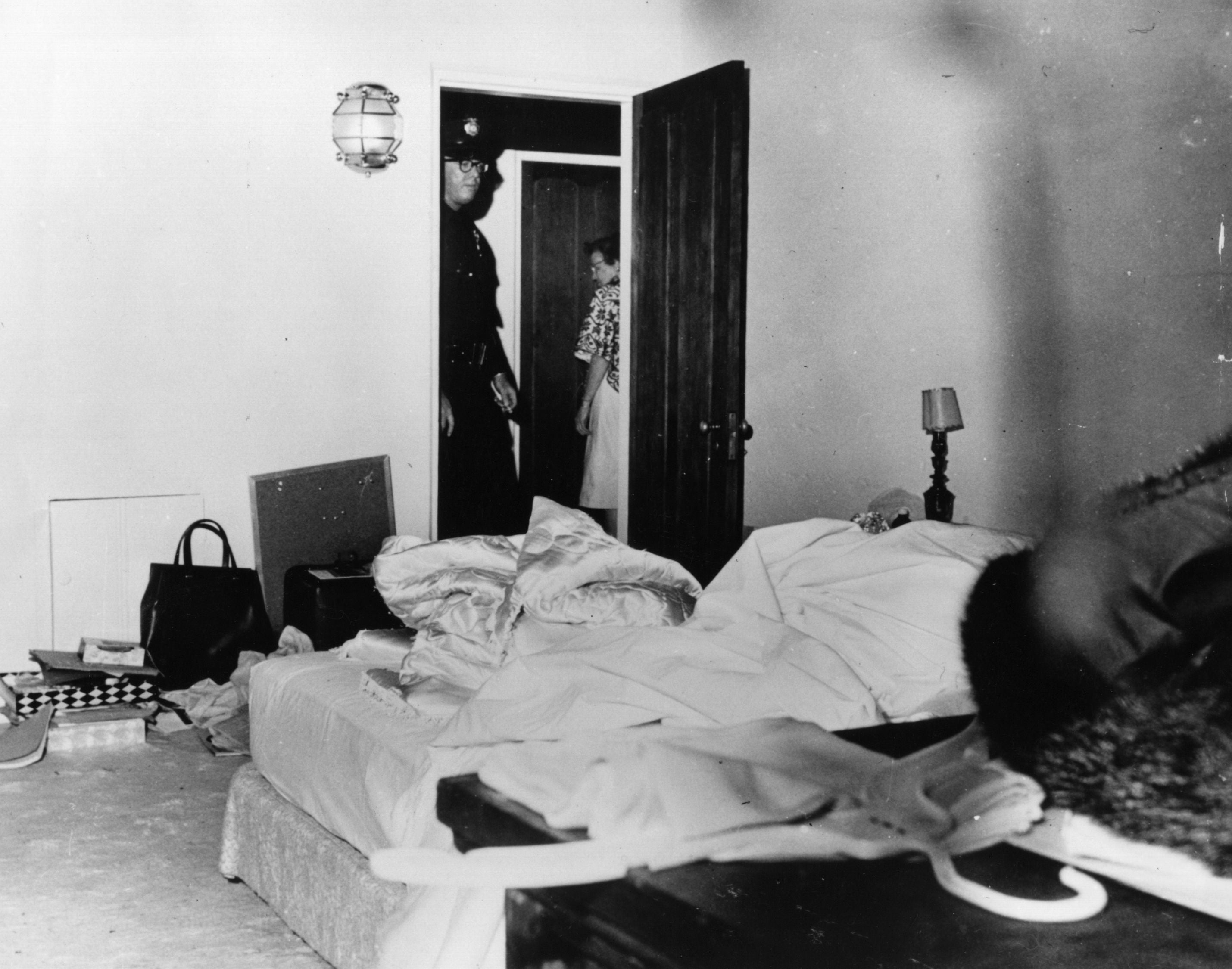 Police inspect the room in Los Angeles where Marilyn Monroe died after a drug overdose