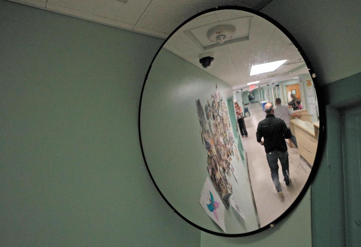 Staff walk in adult residential hallway at the SLO County Psychiatric Health Facility (PHF) in a file photo from Sept. 2, 2015.