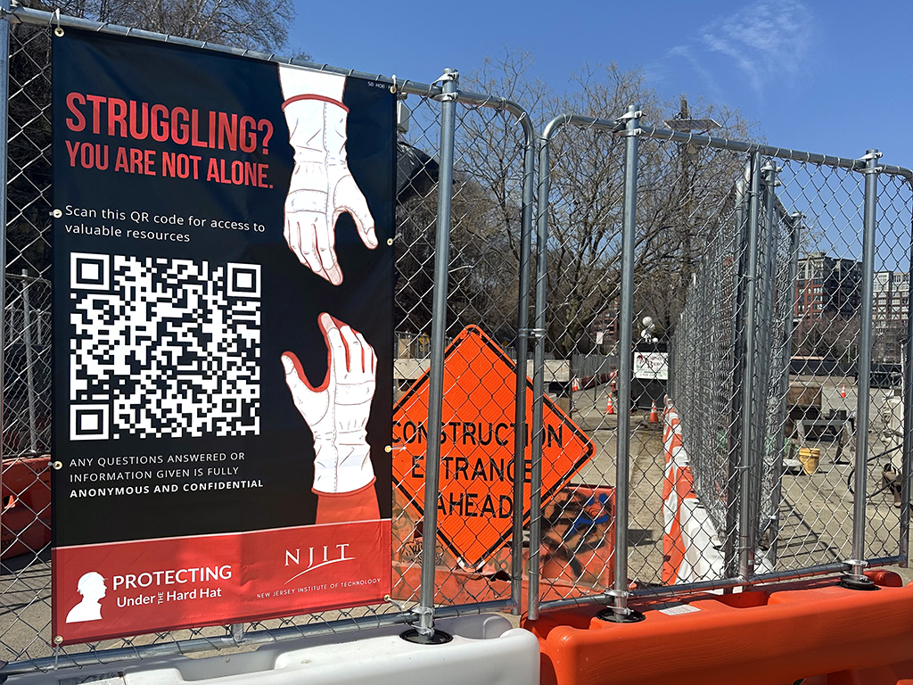 A poster at a New Jersey construction site displays a QR code that workers can scan to take a confidential survey.
