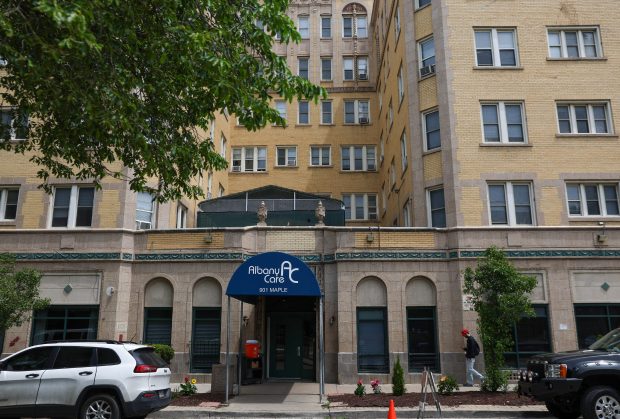 A person walks past Albany Care along the 900 block of Maple Avenue on May 26, 2026, in Evanston. (Stacey Wescott/Chicago Tribune)