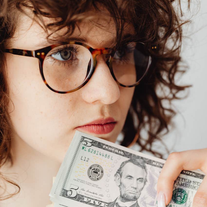 unhappy woman who's only focused on money